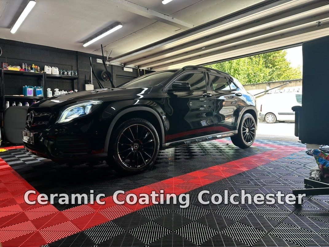Black Mercedes-Benz GLA inside a detailing studio under inspection lighting